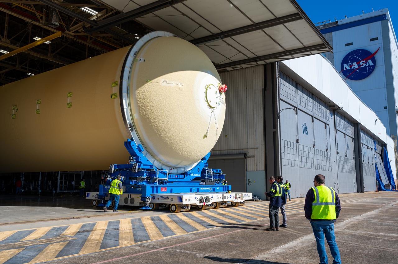 Technicians transported the assembled upper part of the Artemis II core stage to the final assembly area inside the factory at NASA’s Michoud Assembly Facility in New Orleans.  On Jan 10, the forward assembly, left was moved next to the Artemis II liquid hydrogen tank, which has been undergoing assembly. Next, Boeing, the lead core stage contractor, will join the forward assembly and the liquid hydrogen tank to complete most of the core stage for the Space Launch System (SLS) rocket that will send the first crew on an Artemis mission. The core stage consists of five major structures that are built, outfitted, and then connected to form the final stage. The forward skirt, liquid oxygen and intertank were connected and tested to form the 66-foot forward assembly. After the forward assembly is joined with the 130-foot liquid hydrogen tank, only the engine section, the fifth piece of the stage, will need to be added to complete the Artemis II core stage.  The core stage serves as the backbone of the rocket, supporting the weight of the payload, upper stage, and crew vehicle, as well as the thrust of its four RS-25 engines and two five-segment solid rocket boosters attached to the engine and intertank sections. On Artemis II, the SLS rocket will launch the Orion spacecraft and a crew, sending them into lunar orbit, in preparation for later Artemis missions that will enable the first woman and first person of color to land on the Moon.